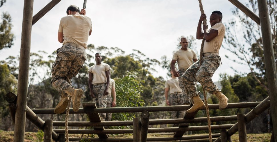 Military soldiers training rope climbing